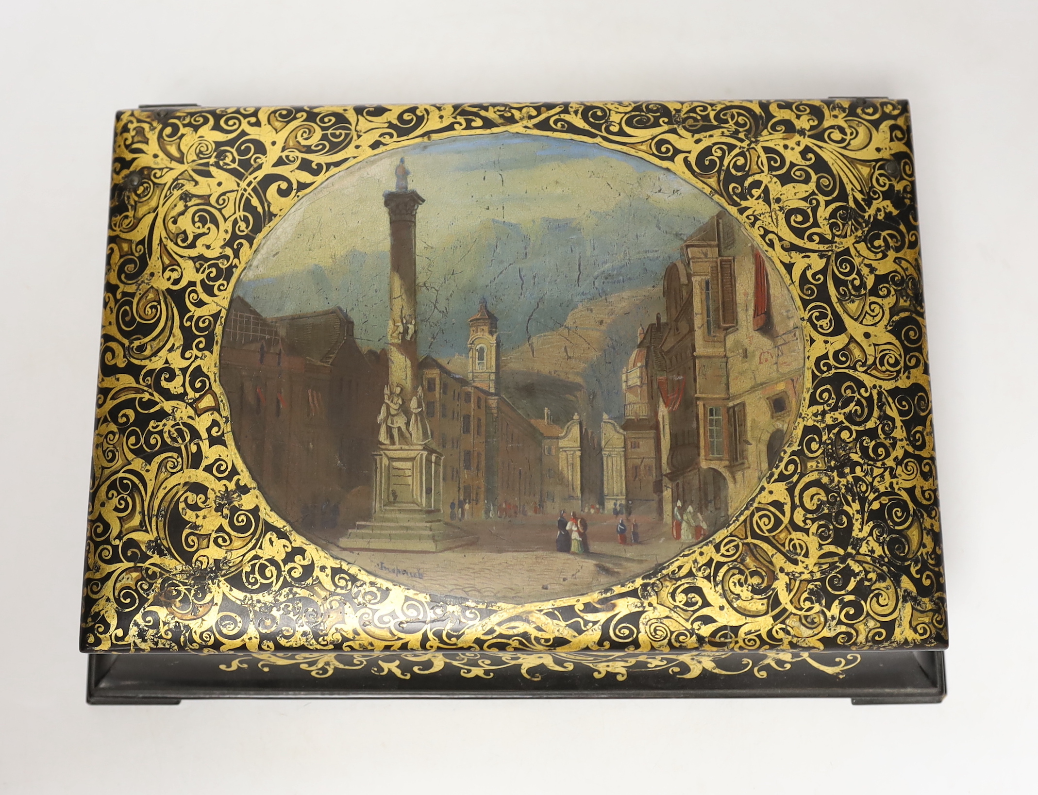 A Victorian stamped Jennens and Bettridge papier mache writing box, hand painted with a continental landscape with fitted watered silk interior, 27cm wide